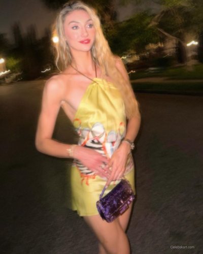Cameron Brink wearing a colorful yellow dress and delicate jewelry.