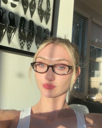 Cameron Brink in vibrant yellow halter dress with playful swirls.