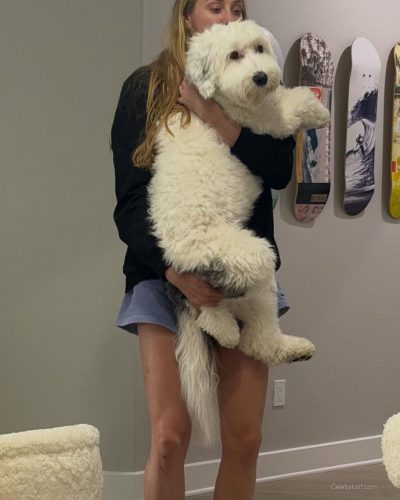Cameron Brink in bright yellow gown with contrasting purple accessory.
