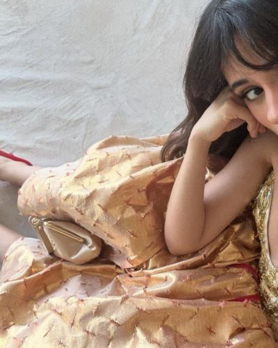 Camila Cabello wearing a vibrant red bikini with tied sides.