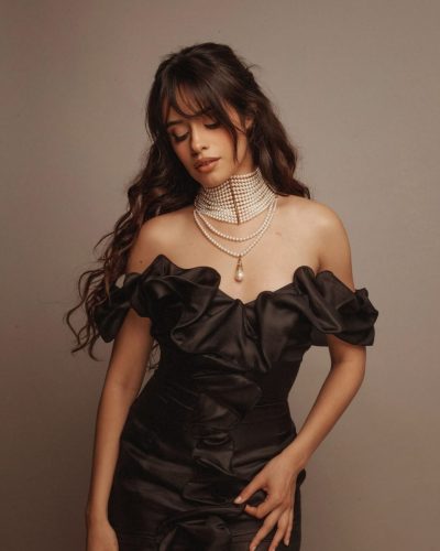 Camila Cabello in a red bikini reflecting summer fun.