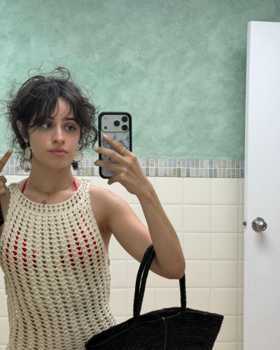 Camila Cabello in a red bikini with tousled beach hair.