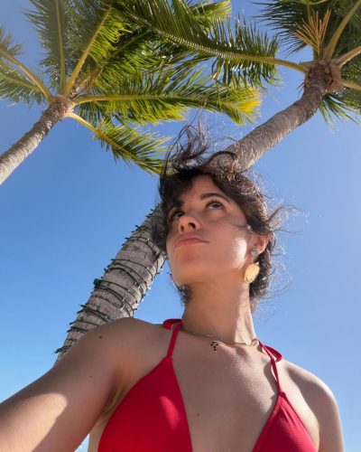Camila Cabello in a chic red bikini at the beach.