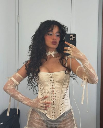 Camila Cabello in a red bikini with tousled beach hair.