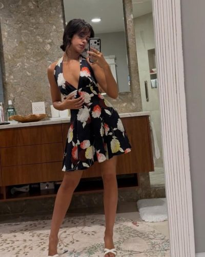 Camila Cabello wearing a vibrant red bikini with tied sides.