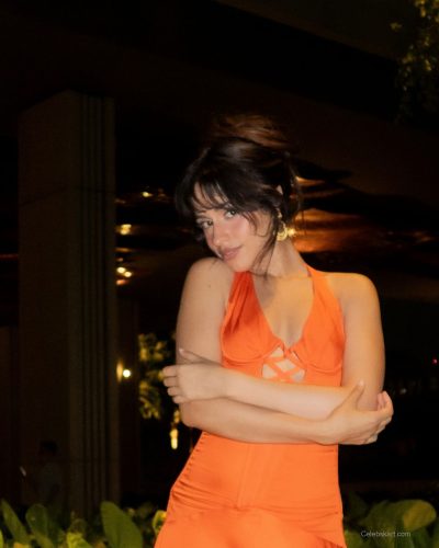 Camila Cabello in a red bikini enjoying a beach day.