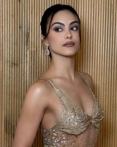 Camila Mendes wearing a gown with sequins catching the light