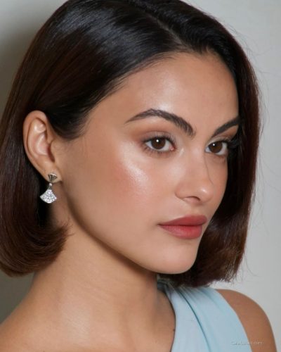 Camila Mendes in light blue dress with asymmetric neckline