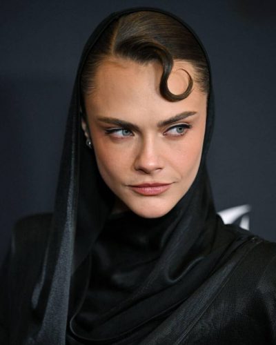 Cara Delevingne high-neck black gown emphasizing her silhouette
