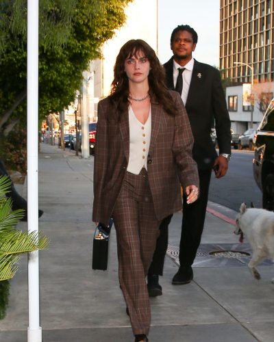 Cara Delevingne in brown plaid blazer and tailored pants