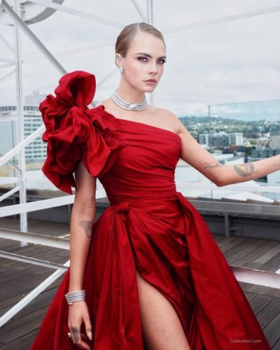 Cara Delevingne in a bold red dress with statement accessories