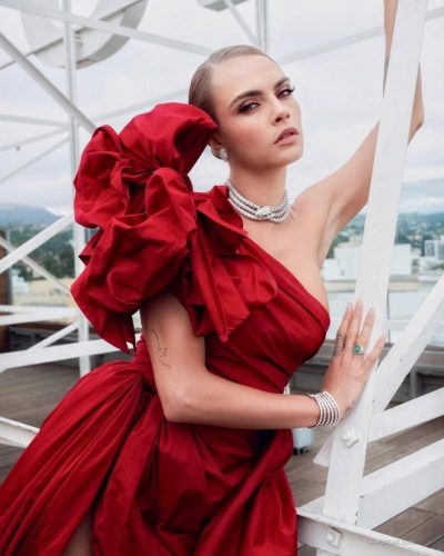 Cara Delevingne in a dramatic red dress with curve-hugging fit