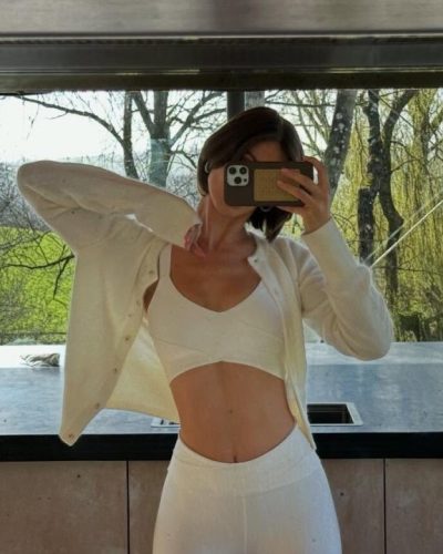 Carmella Rose in light blue sports bra and high-waisted shorts