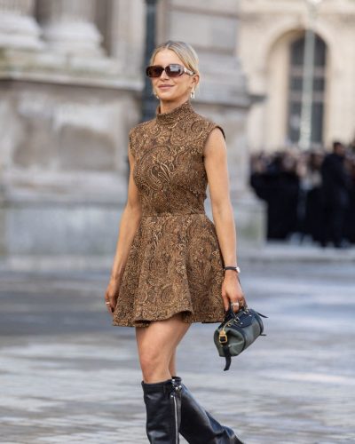 Caroline Daur fashionable green bag paired with dress