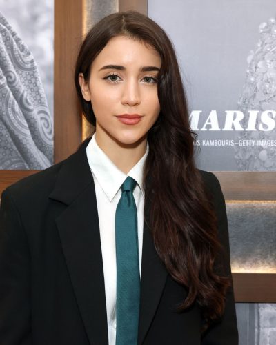 Caylee Cowan in a classic black suit with teal accents