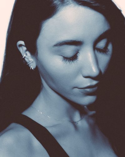 Caylee Cowan in radiant silver dress with playful hem details.