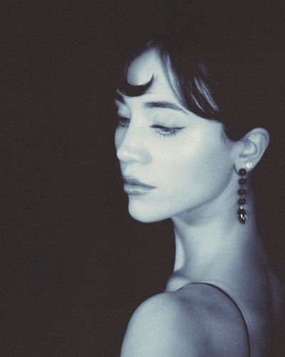 Caylee Cowan wearing a form-fitting silver gown with metallic accents.