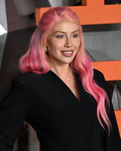 CC Clarke with a fitted black blazer and youthful mini skirt.