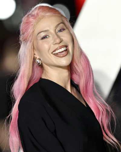 CC Clarke with multiple rings and earrings complementing her style.