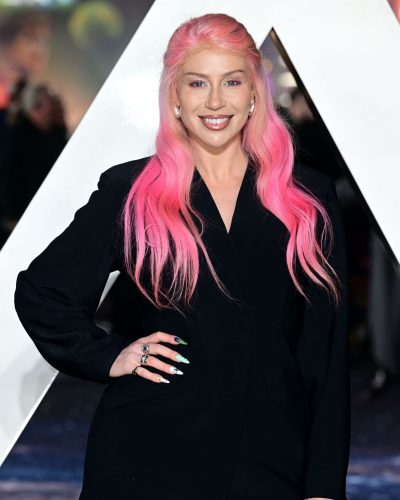 CC Clarke styled in a sophisticated black jacket and mini skirt.