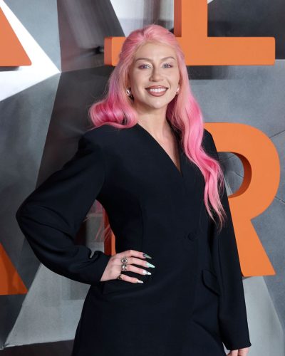 CC Clarke accessorized with rings and stylish earrings.