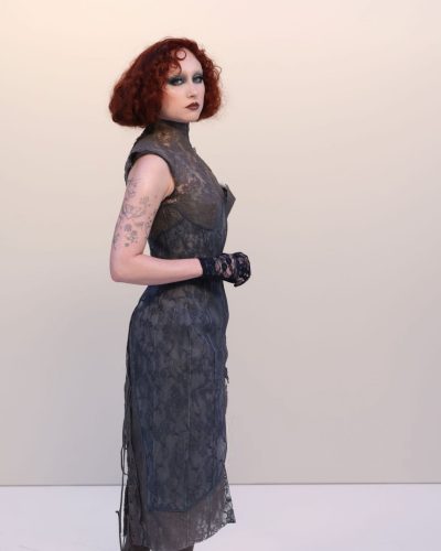 Chappell Roan lace gloves complementing gray fitted dress design