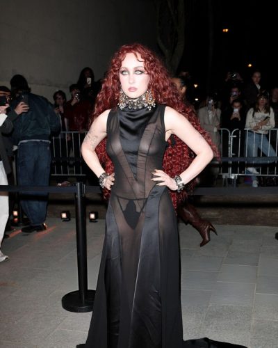 Chappell Roan in a black dress featuring a daring silhouette.