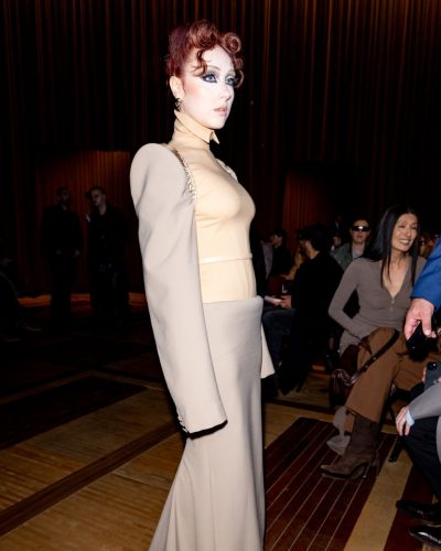 Chappell Roan wears a chic beige dress with eye-catching details.