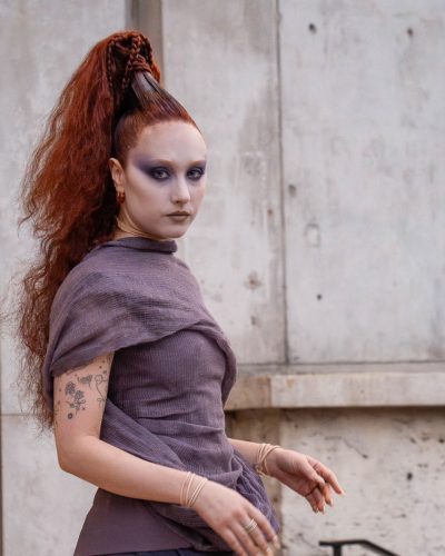 Chappell Roan wearing a dramatic lavender gown with high slit