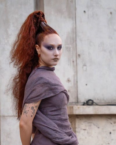 Chappell Roan in flowing gown with high slit and lavender hue