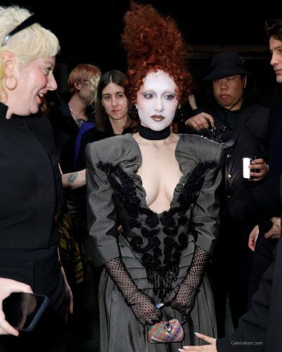 Chappell Roan wearing a gray plunging neckline dress