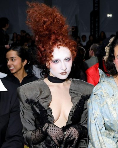 Chappell Roan in gray long sleeve dress with dramatic neckline