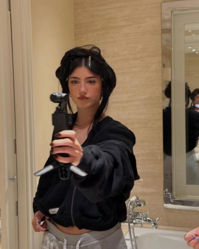 Charli D'Amelio in comfortable black hoodie and gray sweatpants