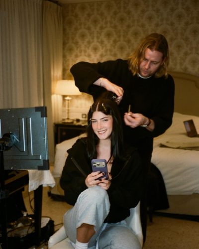 Charli D'Amelio with gray sweatpants and black cropped sweatshirt