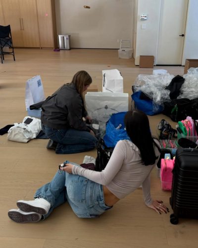 Charli D'Amelio in black cropped sweatshirt and light gray joggers