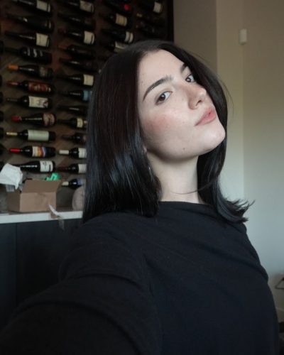 Charli D'Amelio wearing black hoodie with soft gray sweatpants