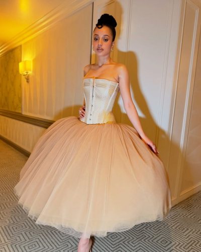 Chase Infiniti in a sophisticated dress with cascading tulle.