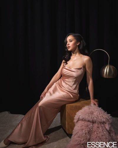 Chase Infiniti in eye-catching blue fur coat and neutral backdrop.