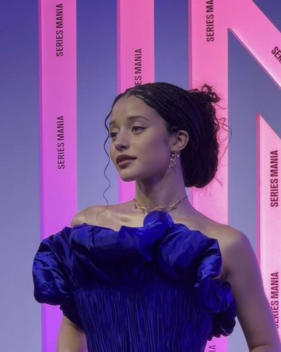 Chase Infiniti in elegant blue gown with puffed sleeves.