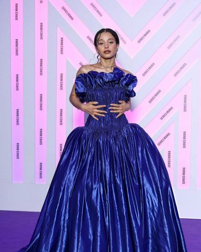 Chase Infiniti wearing stylish blue dress with detailed craftsmanship.