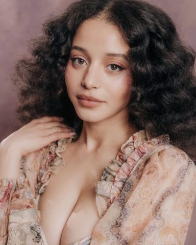 Chase Infiniti wearing layered fabric details in her attire.