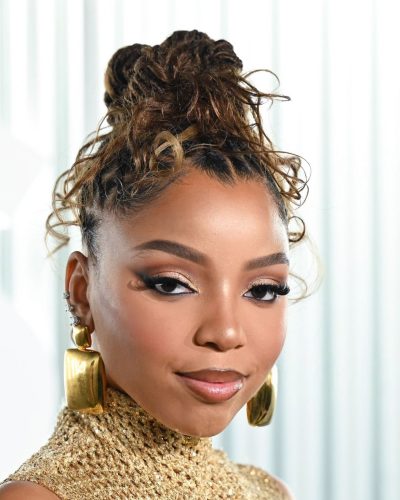 Chloe Bailey in a gold gown featuring daring side cutouts