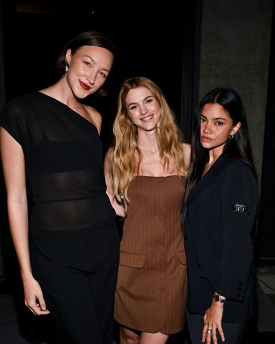 Chloe East wearing fitted brown dress with front pockets