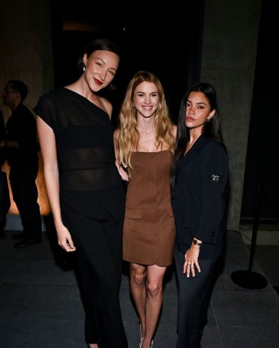 Chloe East in chic brown dress with elegant white footwear