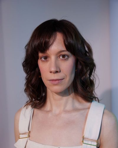 Chloe Pirrie chic neutral heels matching her tailored dress.