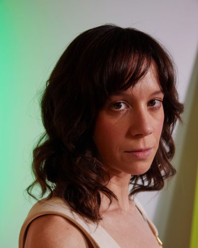 Chloe Pirrie flowing beige dress with delicate gold details.