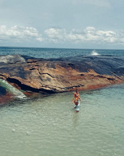 Cintia Dicker in a colorful feathered headpiece and golden attire