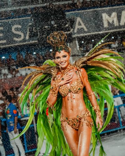 Cintia Dicker in a sparkling gem-adorned costume with emerald accents