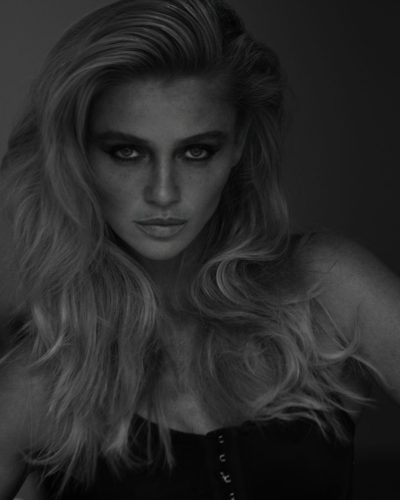 Cintia Dicker dressed in a bold gold gown with lush green feathers