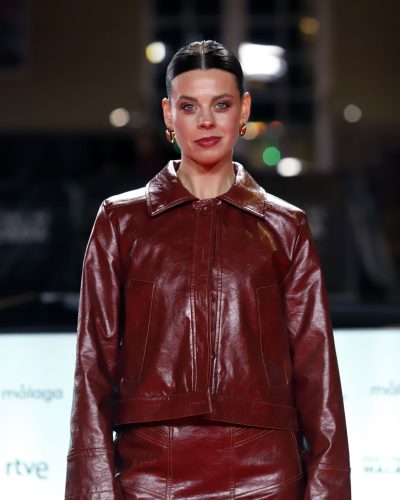Clara Alvarado wearing chic burgundy leather jacket and skirt